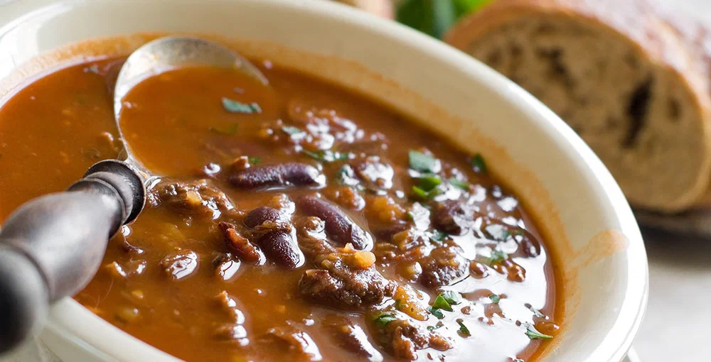 A bowl of homemade chili bean soup with meat, selective focus