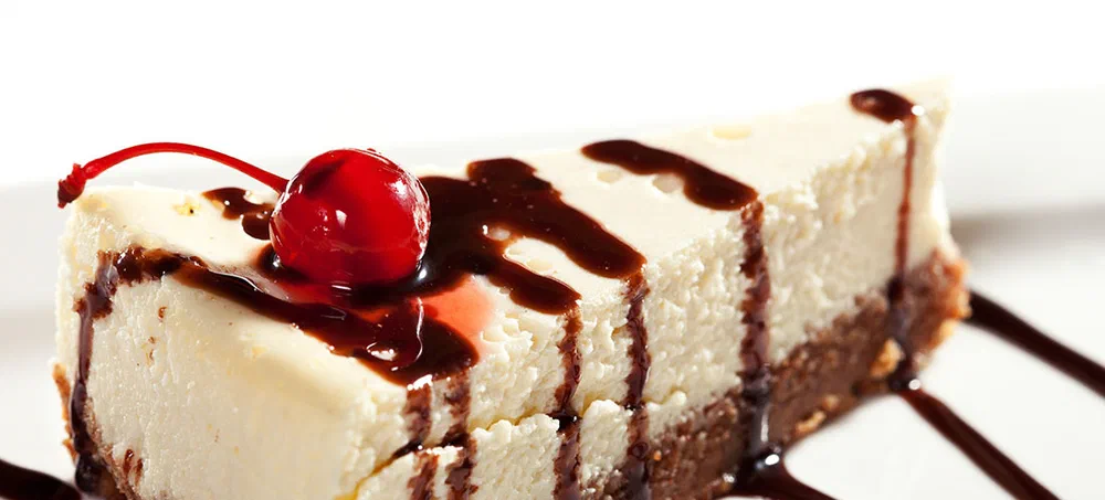 Cheesecake with Chocolate Sauce and Cherries