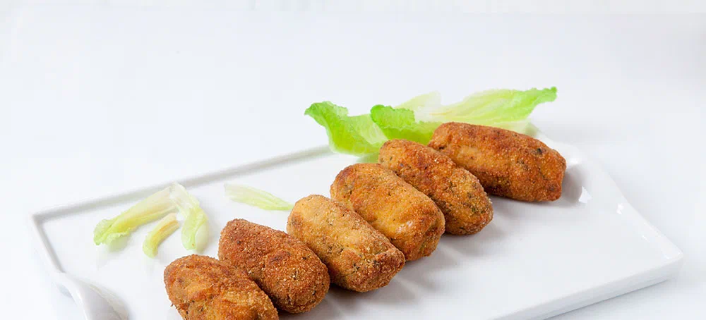 homemade chicken and vegetables croquettes on white tray