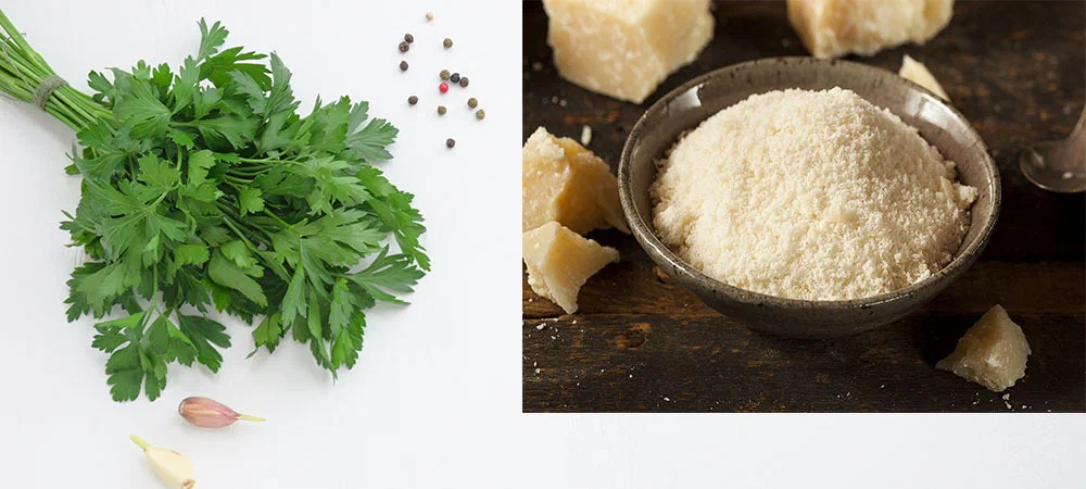 a bunch of parsley, garlic and pepper on a white wooden background