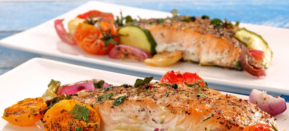 Baked salmon with herbs and vegetables on the plate