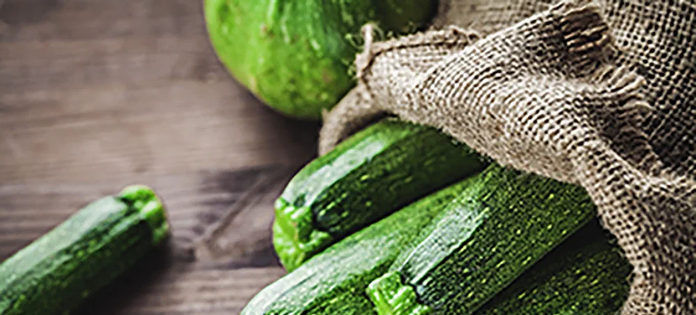 fresh zucchini in a jute sack